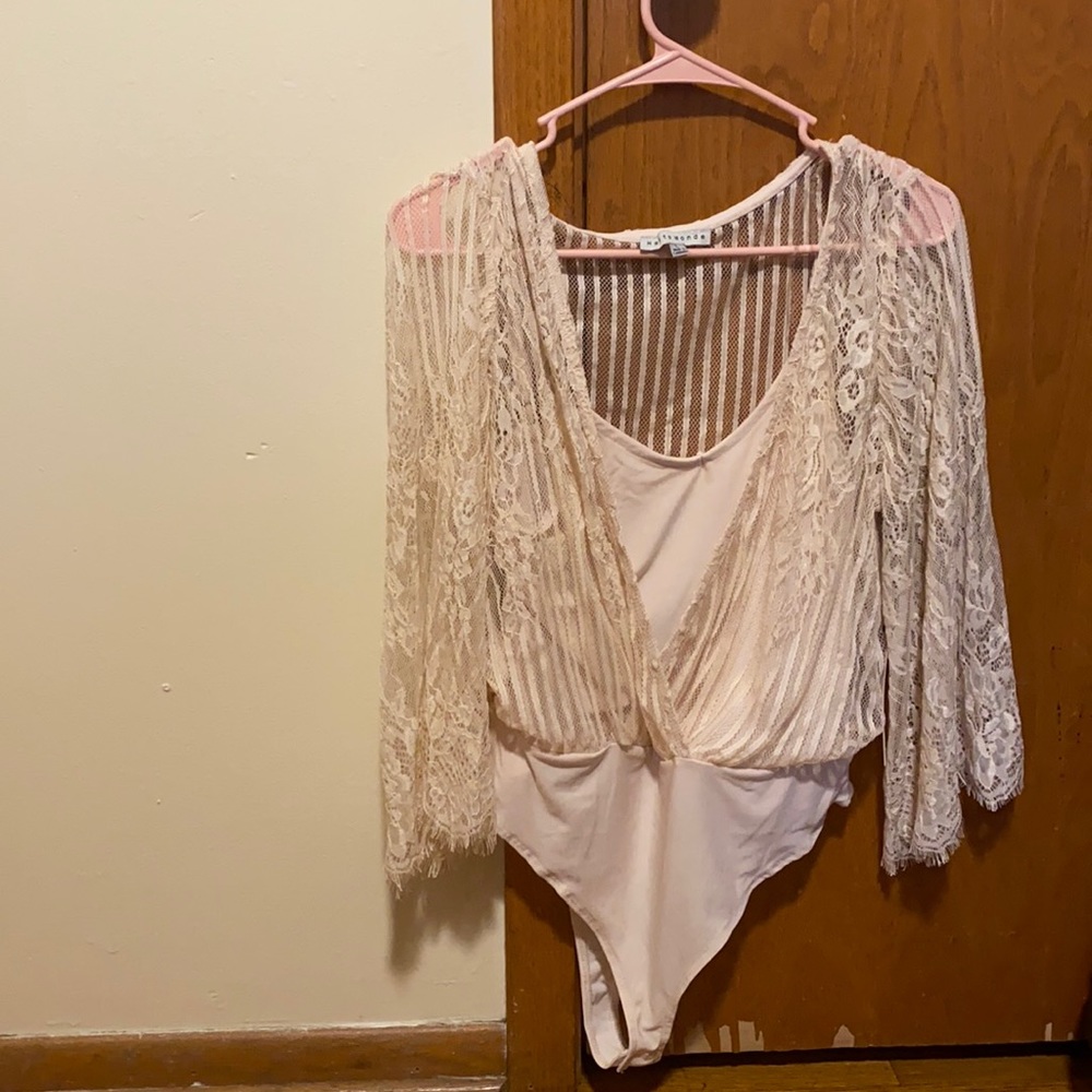 Tan/cream bodysuit cover by a floral sheer